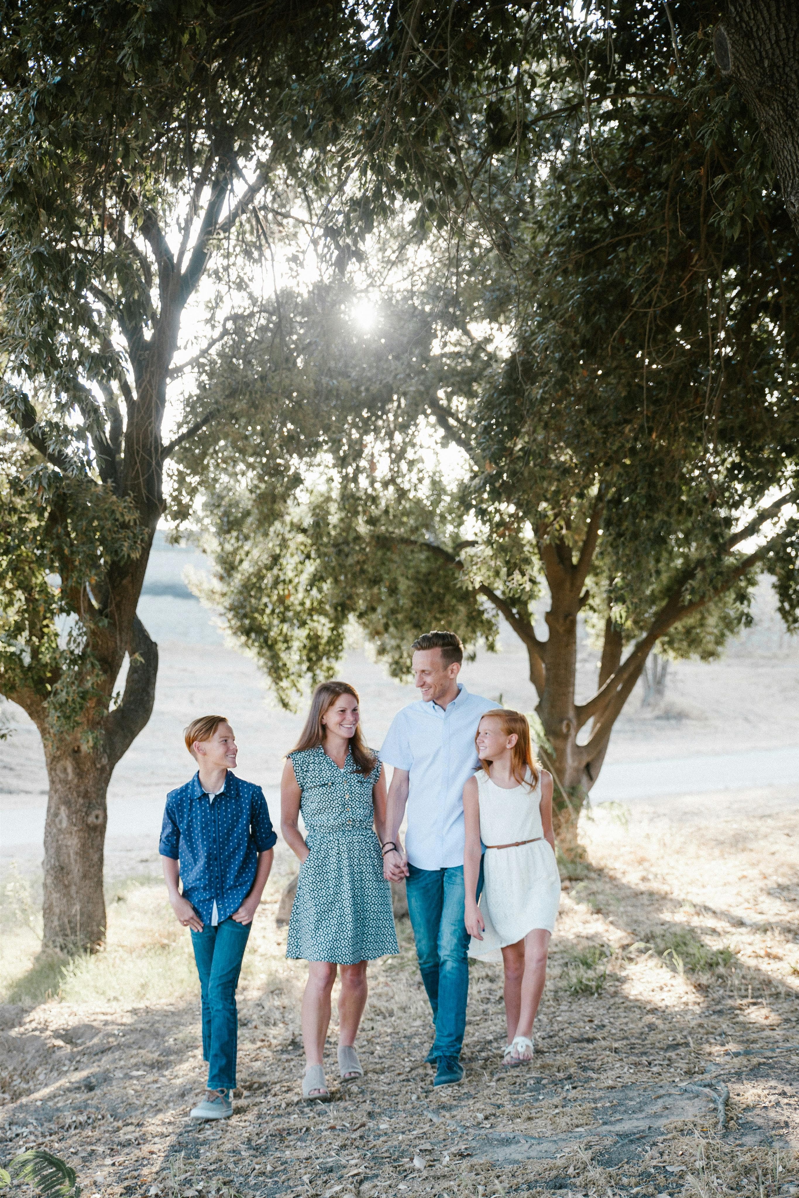 Family standing together in front of trees, representing the TwalkOn parenting community